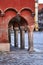 Stone columns of arcades of historic tenement houses on the market square