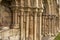 Stone columns and figures carved on a medieval abbey ruin.