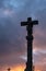 Stone cross in a cemetery in Galicia. Silhouette in a stormy sky at sunset