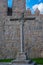 Stone cross in front of the walls of Avila