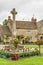 Stone cross in garden, Castle Combe Village, Wiltshire, England