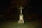 A stone cross glowing in the dark.