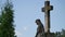 Stone cross at the old cemetery. Dark Gothic graveyard. Clouds over an abandoned cemetery. Old graves during the first