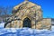 Stone Crypt in Snowy Cemetery