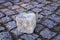 Stone cube on paving stone surface of walkway in Europe