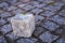 Stone cube on paving stone surface of walkway in Europe
