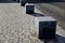 Stone cubes barriers as protection of a nice lawn cube cubes on a paved sidewalk platform of a tram protected from the entry of ca