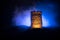 Stone defence tower at night. Medieval castle miniature with toned foggy backlight. Creative table decoration