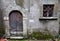 Stone entrance portal and wooden door of the entrance of an ancient house, no longer inhabited but suggestive, in Vergemoli.