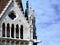 stone facade detail in neo Gothic style with projecting gargoyle of lion face