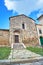 Stone facade of a historic house in the town of Magliano in Toscana