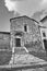 Stone facade of a historic house in the town of Magliano in Toscana