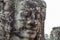 Stone face relief of ancient buddhist temple Bayon in Angkor Wat complex, Cambodia. Sightseeing in Cambodia