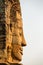 Stone face on the tower of ancient Bayon Temple