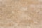 Stone facing of beige wall made of travertine. Texture of masonry.