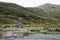 Stone famine memorial in Doo Lough Valley of Connemara, Ireland with rocky hillside in background