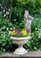 Stone Flower container with pansies and a stone st