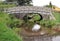 Stone foot Bridge over the Brecon and Monmouthshire canal in South Wales with narrowboat