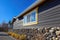 stone foundation and wooden shingle siding home against blue sky