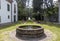 Stone fountain in the gardens surrounded by trees of the Pazo de MariÃ±Ã¡n in Galicia, Spain