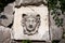 Stone fountain head in a garden