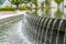 Stone fountain with trickling water and pool at the Utah State Capital Builidng