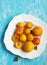 Stone fruits on plate. Yellow plums, apricots and nectarines