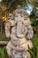 Stone Ganesha statue with flowers