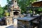 Stone gas fireplace in the garden in the outdoor kitchen