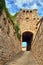 A stone gate, stairs and a narrow street  in the city of Massa Maritima