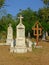 Stone gravetombs and woorden cross on a cemetery  in the Romanian countryside