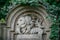 A stone graveyard tomb with relief flowers