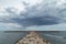 Stone Groyne Pier at Camargue with Dramatic Clouds above Sea