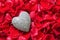Stone heart in rose petals
