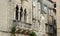 Stone house with windows and balcony in the street of old town, beautiful architecture with sculpture, sunny day, Trogir, Dalmatia