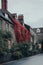 Stone houses covered in colourful foliage on a street in Frome, Somerset, UK