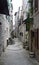 Stone houses in narrow street of old town, beautiful architecture, sunny day, Trogir, Dalmatia, Croatia