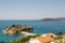 Stone houses with red roofs on the island of Sveti Stefan in the Bay of Kotor