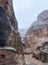 Stone houses or Tombs in curved rocks at heavy rain in Little Petra - ancient Nabatean city