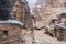 Stone houses or Tombs in curved rocks at heavy rain in Little Petra - ancient Nabatean city