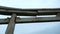 Stone Japanese Arch. Clip. Stone arch in Chinese style on background cloudy sky. Close-up of part of stone arch on