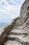 Stone ladder cut from the rock over sea