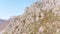 Stone ledge against the blue sky. Shot. Aerial view of a rocky ridge