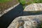 Stone lining of bank at the mouth of the sewer pipe with a grate against the entry of persons into the treatment plant or industri