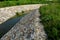 Stone lining of bank at the mouth of the sewer pipe with a grate against the entry of persons into the treatment plant or industri