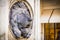 Stone lion head served as fountain - detail of sculpture of Saints Joseph and Leopold on Graben street in Vienna, Austria