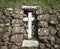 Stone made cross on a rural stone made wall