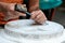 Stone mason at work carving an ornamental relief