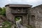 Stone medieval gates with a stone wall next to.