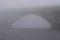 Stone Metro subway bridge in rich fog, mist background. Winter morning view. Kyiv, Ukraine